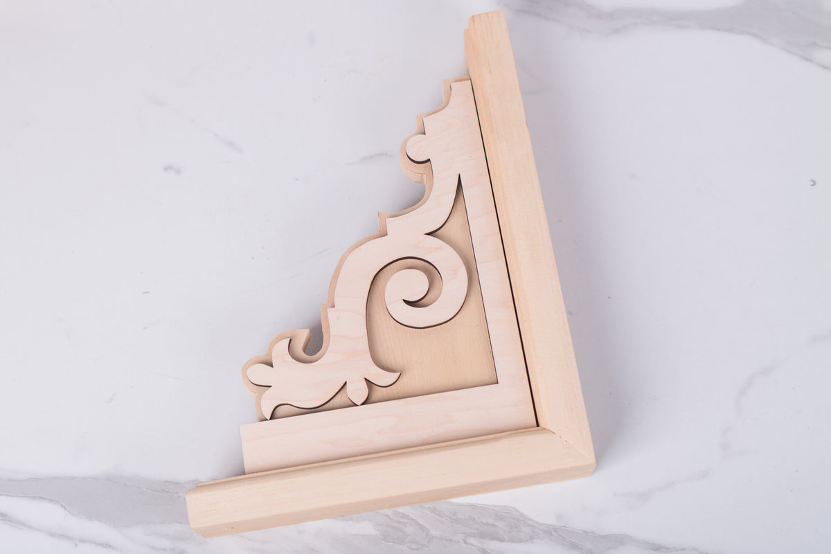 Decorative wooden corbel with intricate carvings on a white background