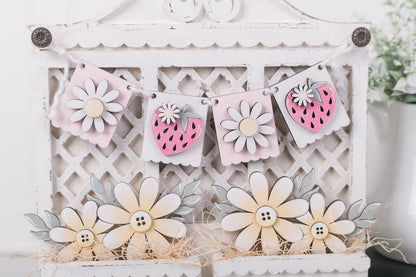 Decorative wooden flowers and berries on a white lattice background