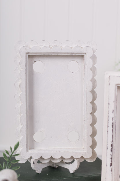 Decorative white scalloped frame on a light gray background