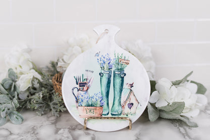 Round ceramic spoon rest with watercolor boots and birdhouse