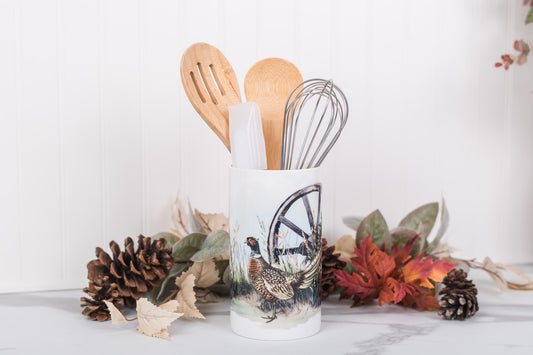 Kitchen utensil holder with utensils featuring a pheasant design on a white background