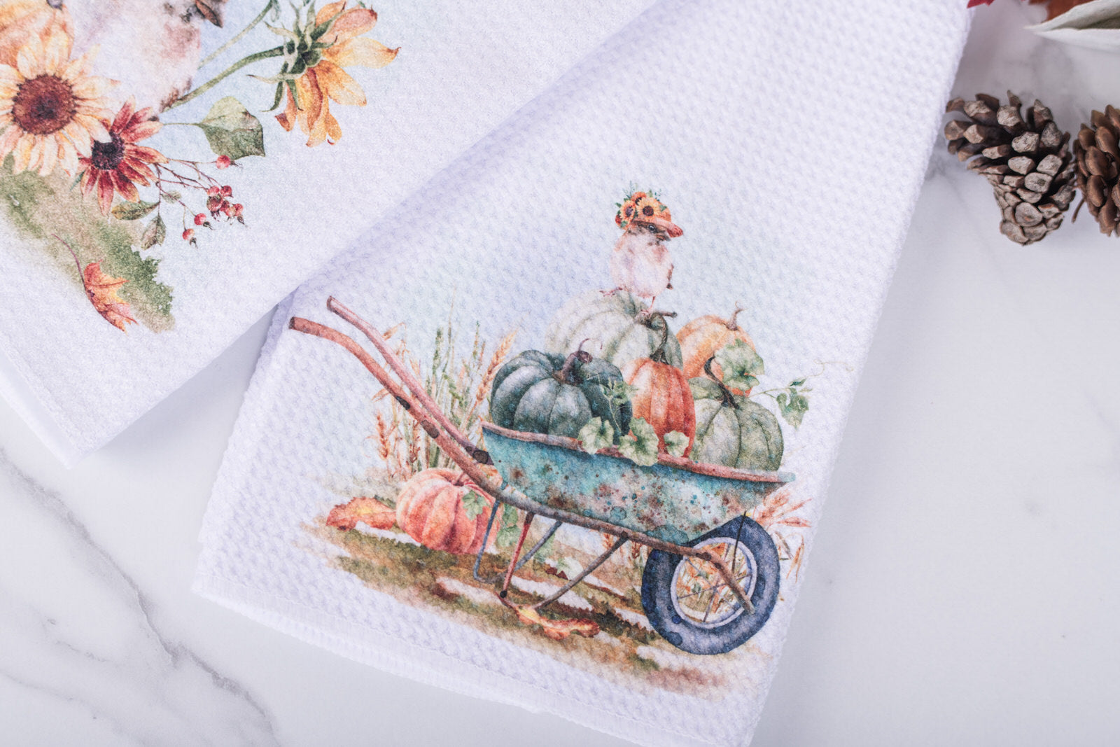 Napkin with a wheelbarrow of pumpkins design on a white surface