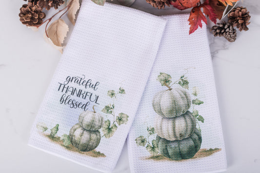Pumpkin Patch Collection tea towels with gratitude text and stacked pumpkins artwork