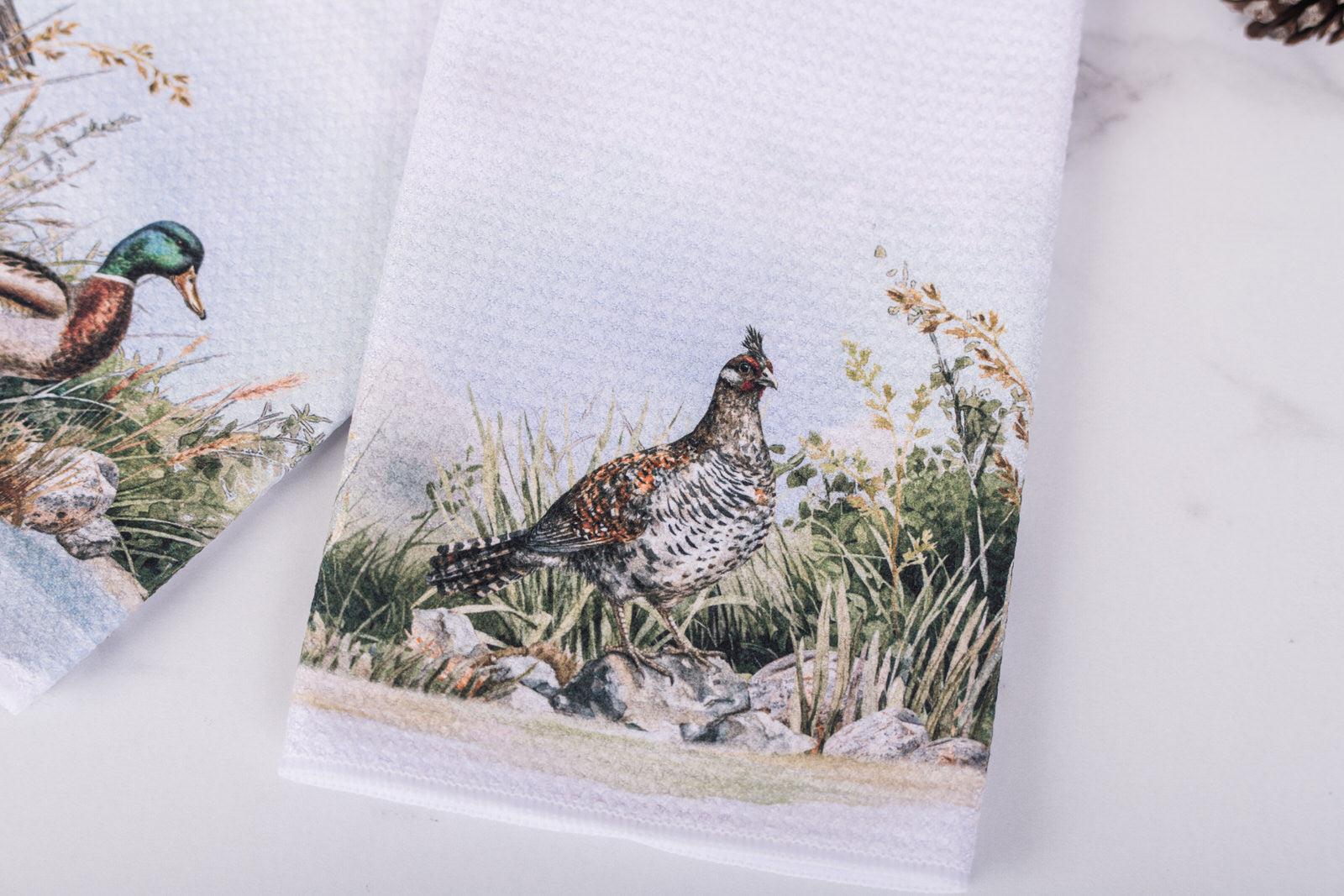 Towel with a grouse design on a white background