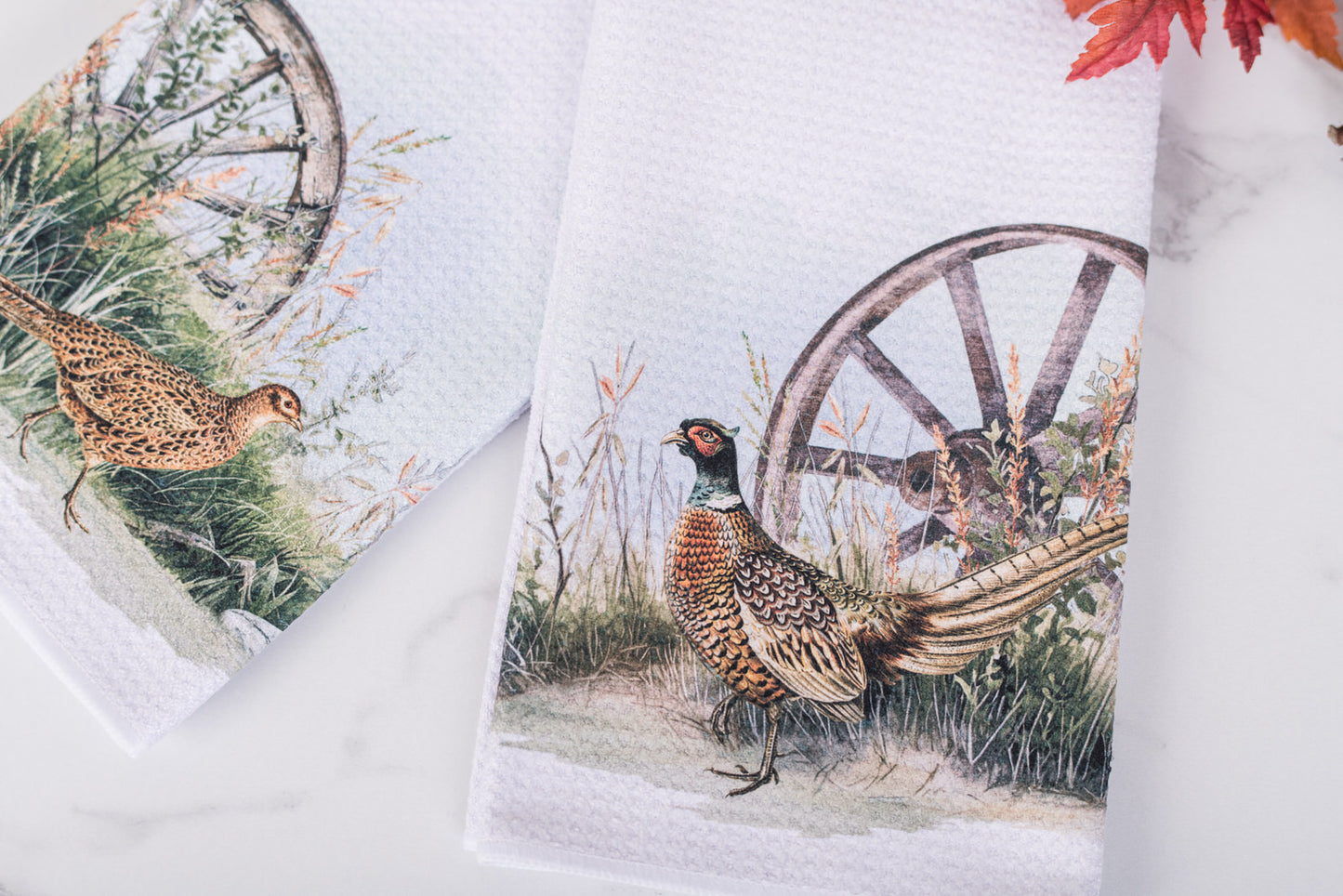 Towels with pheasant and wagon wheel design on a white background
