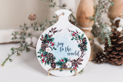 Festive holiday spoon holder styled with pinecones and candlesticks