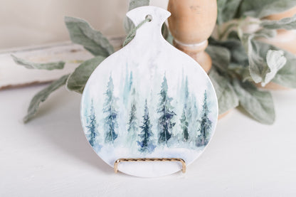 Soft green and blue evergreen spoon holder on white counter