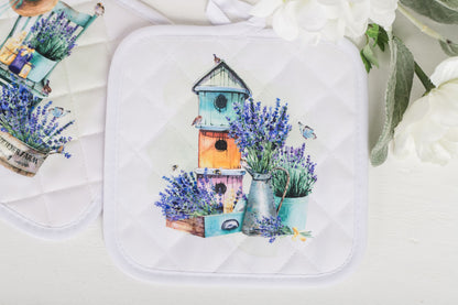 Lavender potholder featuring watercolour birdhouse design on white background 
