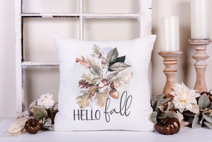 A white velveteen pillow cover with 'Hello Fall' text and a leaf and acorn design