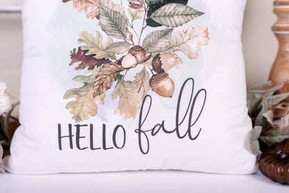Close-up of hello fall script on a fall Oakleaf an acorn on a velveteen pillow cover 