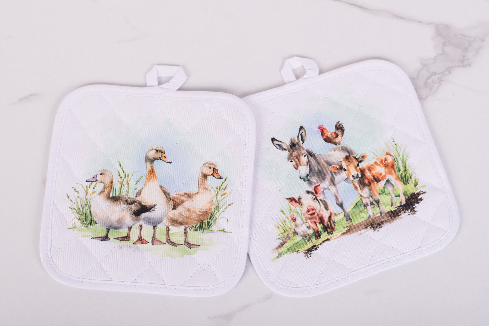 White quilted potholders with farm animal designs from the Homestead Collection