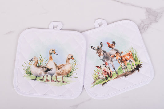 White quilted potholders with farm animal designs from the Homestead Collection