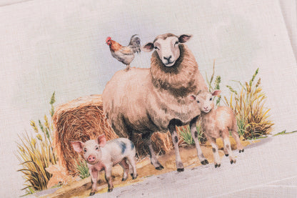 Sheep, lambs, and a chicken in a pastoral setting with hay bale and grass.