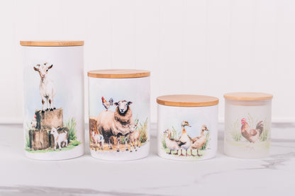 Four ceramic jars with animal-themed designs on a white surface