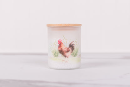 Small frosted glass canister with rooster design on kitchen counter