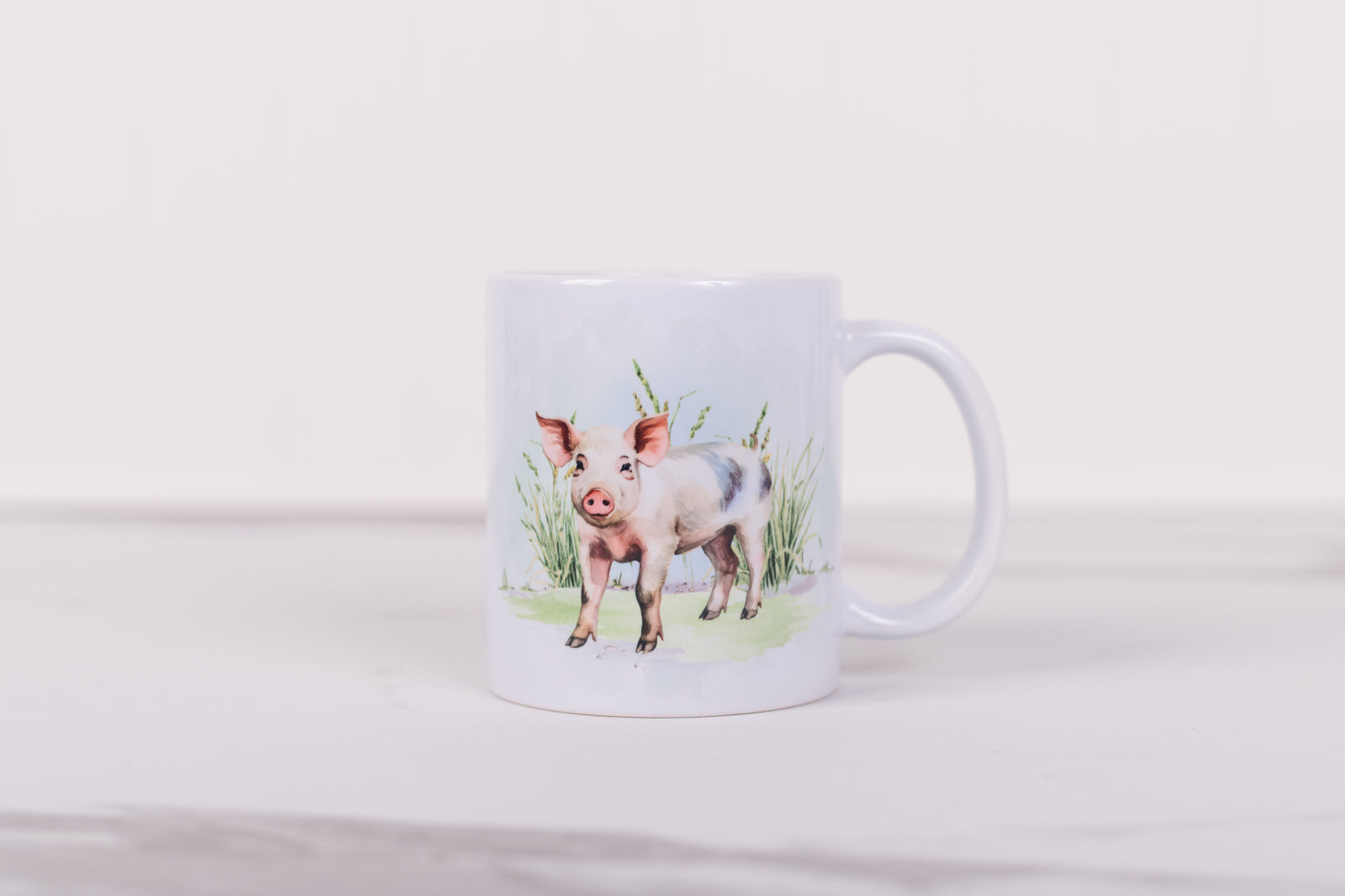 White mug with a pig illustration on a white background