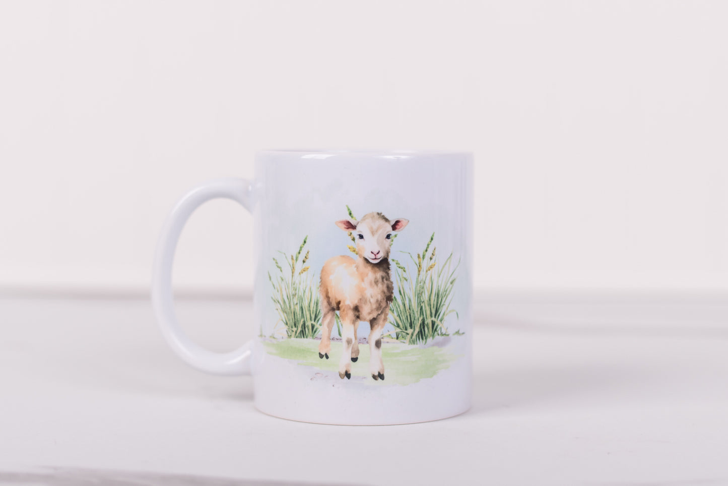 White mug with a design of a lamb on a white background