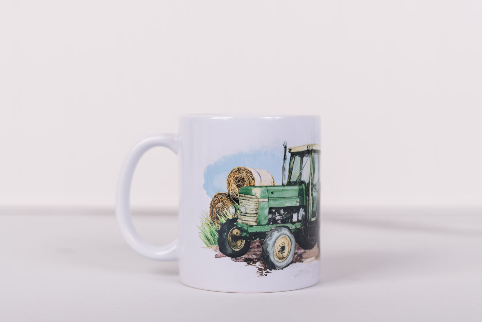 White mug with a design of a tractor and trailer on a white background