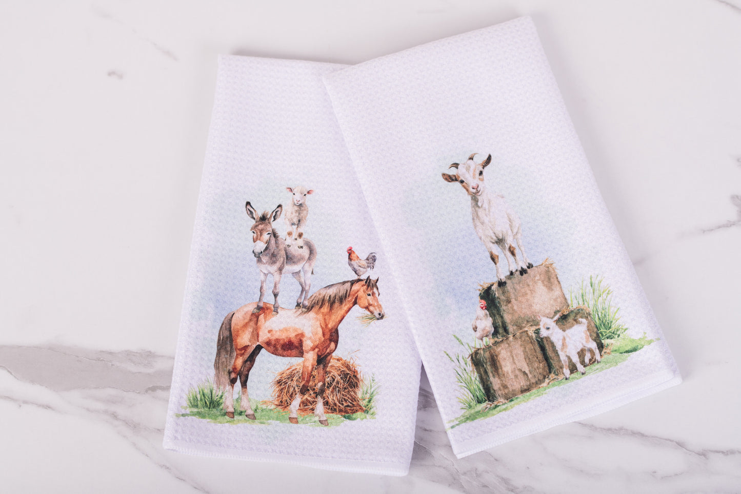 Two towels with animal prints on a white surface