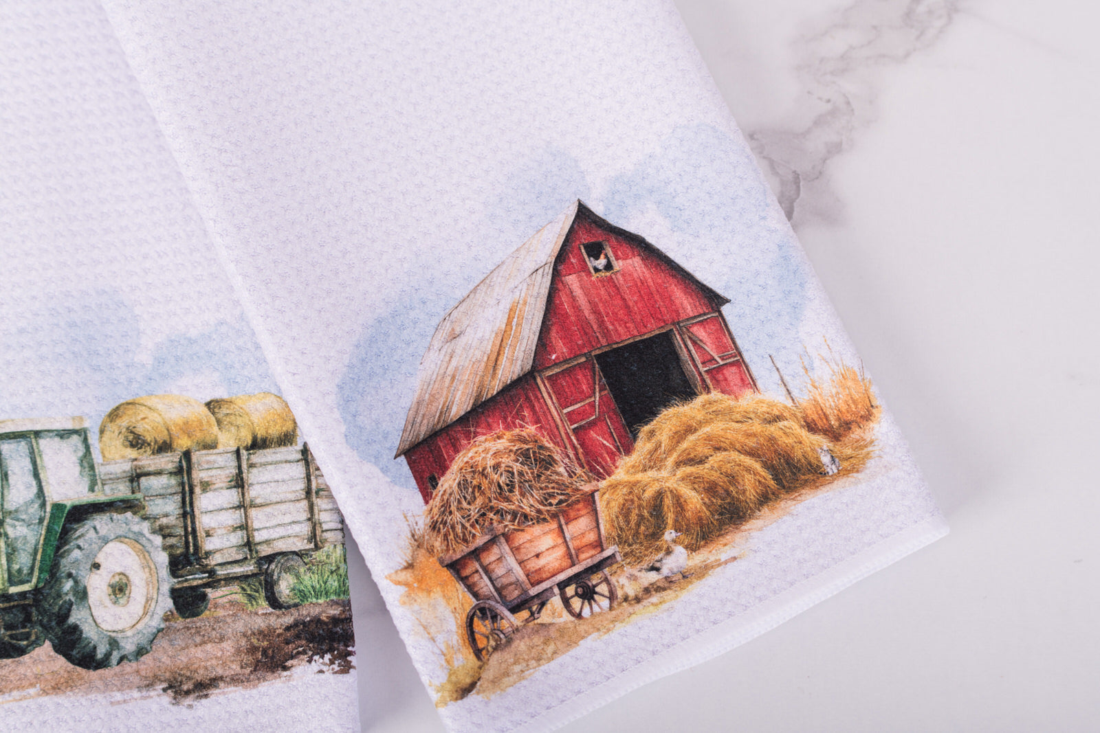 Homestead tea towel with red barn and hay cart