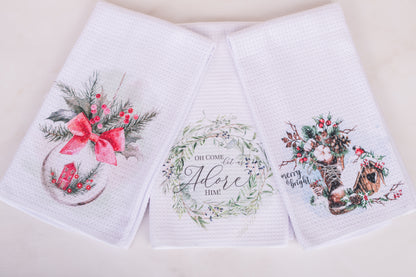 Christmas tea towel set folded on kitchen counter