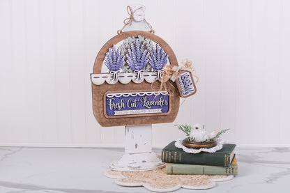 Decorative basket with DIY lavender Kit and a sign on a white surface