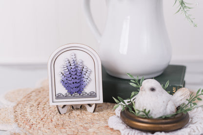 Lavender mini arch decor displayed with white pitcher and florals