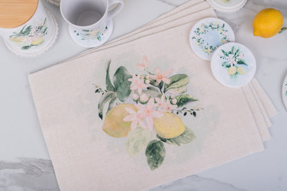 Placemats with floral and lemon designs on a light surface