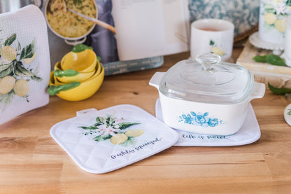  kitchen counter top styled with lemon decor and lemon potholders