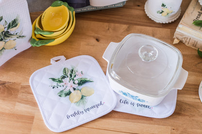  freshly squeezed and life is sweet lemon pot holder on a butcher block