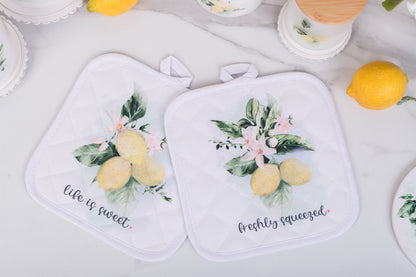  set of lemon potholders styled on a marble countertop