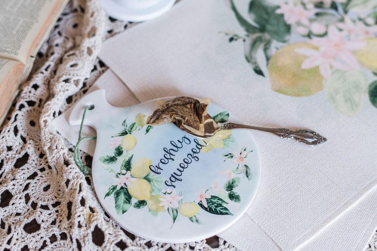 Decorative ceramic spoon holder with spoon holding a teabag