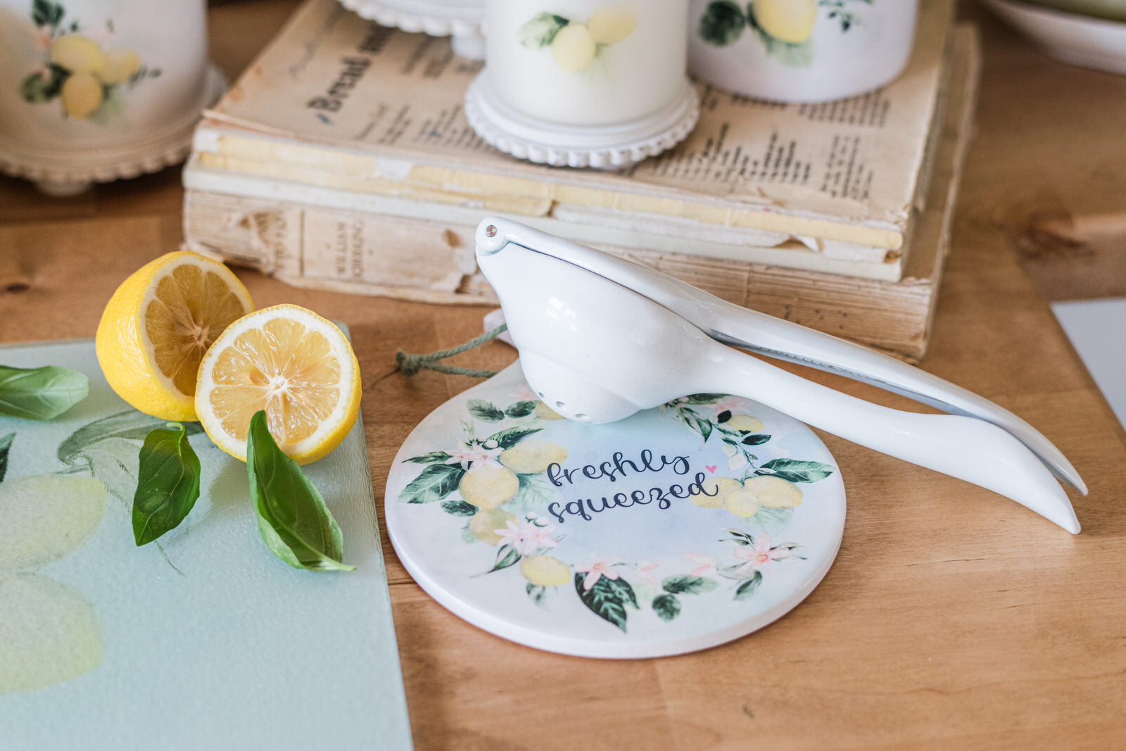 Lemon squeezer on a spoon holder with lemons and a book in the background