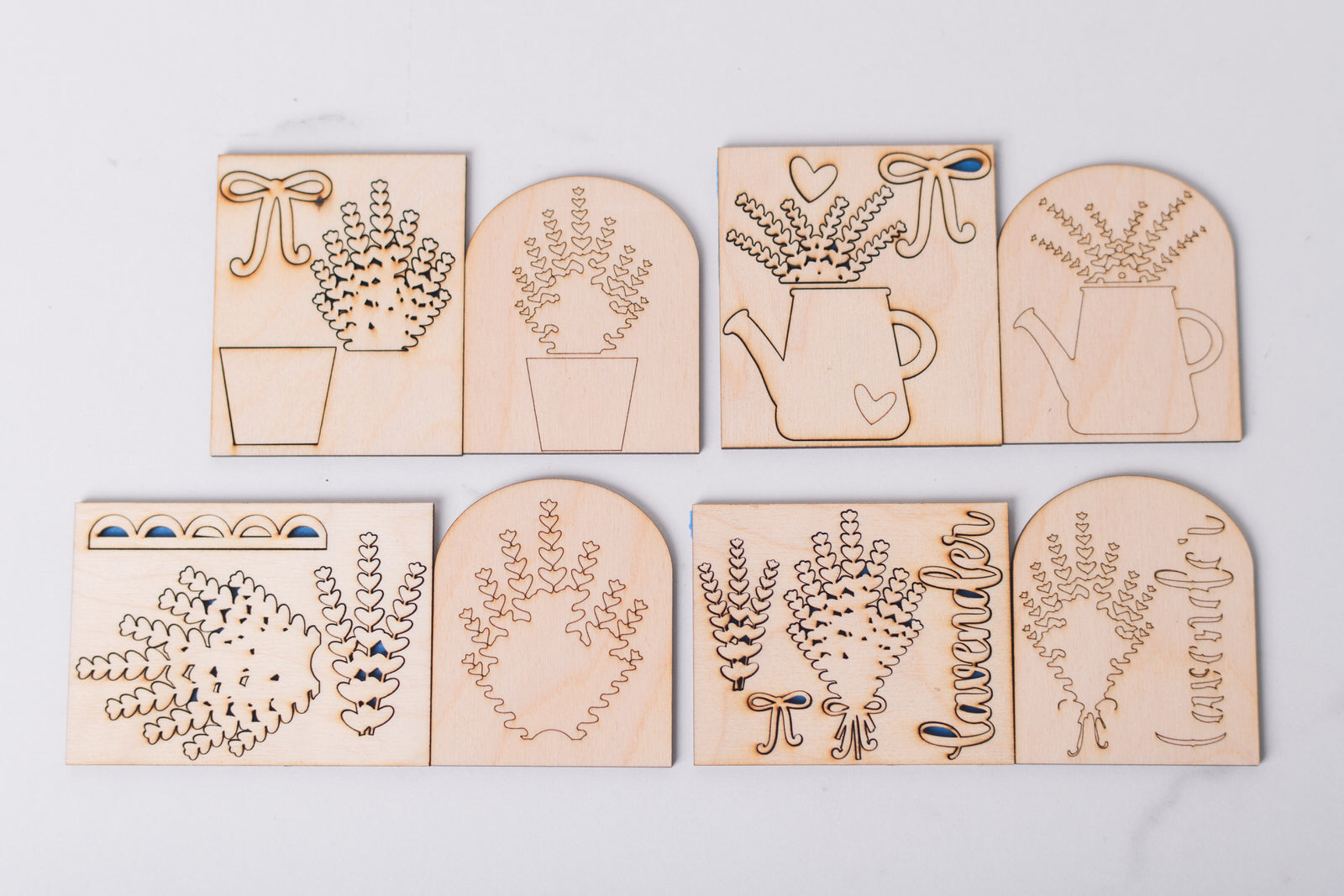 Set of wooden laser-cut lavender inserts with garden designs on a light gray background