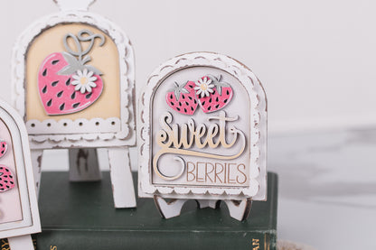 Decorative wooden DIY signs with strawberry designs and 'sweet berries' text on a white background.