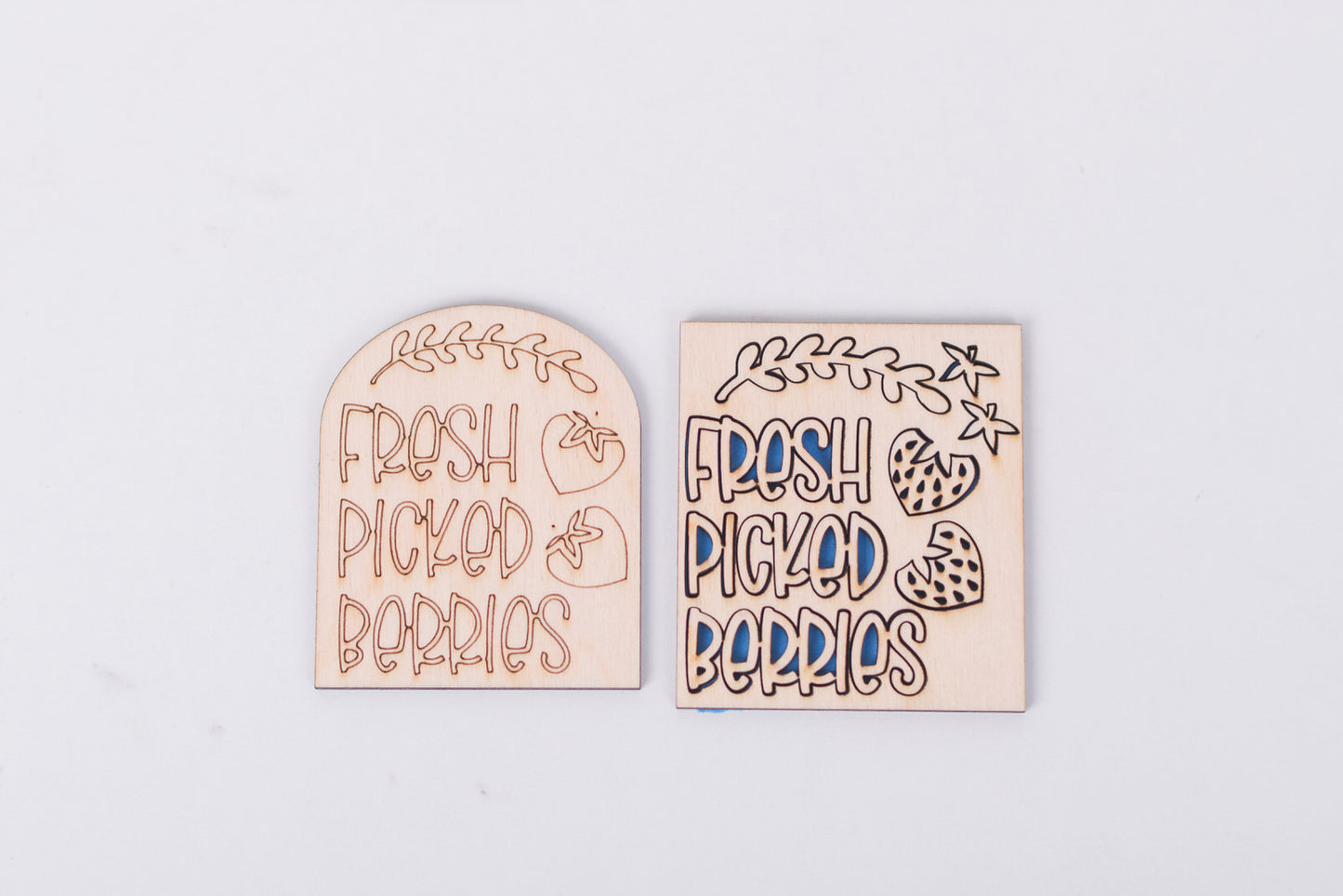 Two wooden signs with 'Fresh Picked Berries' text on a light gray background