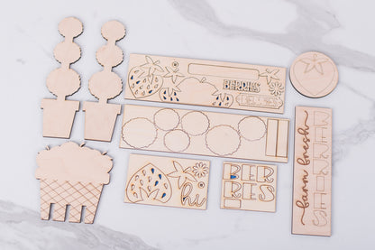 Collection of wooden cutouts with engraved designs on a marble surface
