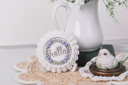 Mini Scallop frame DIY kit with 'hello' text and a small bird figurine on a textured surface.