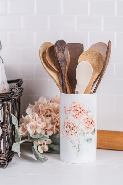 Peach and pink floral utensil holder styled in farmhouse kitchen scene
