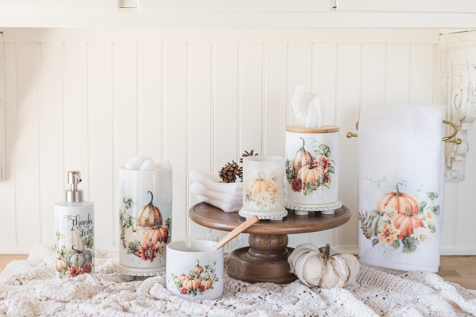 Bathroom jars for fall with guest bath decor items with pumpkin and floral designs on a counter