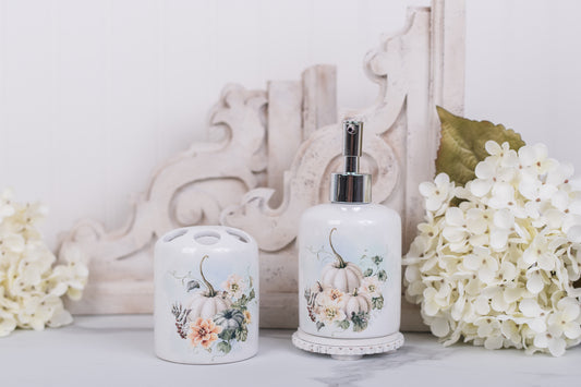 Decorative bathroom set with floral and pumpkin design on a white surface