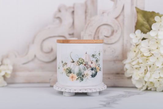 Small ceramic canister with soft white pumpkins and bamboo lid