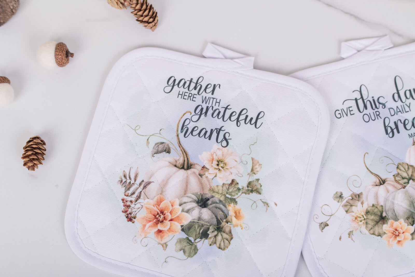 Quilted fall potholders with pastel pumpkins and floral art, with gather here with grateful hearts text