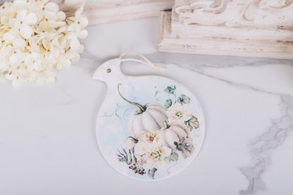Ceramic hot pad with soft watercolor pumpkins and flowers