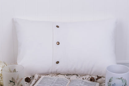 White pillow with snaps on a white background