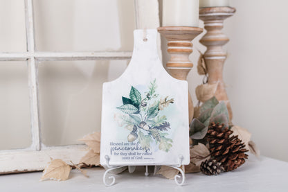 Rectangular ceramic trivet with 'Peacemakers' scripture and fall acorns on kitchen counter