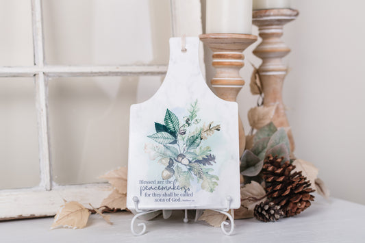 Rectangular ceramic trivet with 'Peacemakers' scripture and fall acorns on kitchen counter