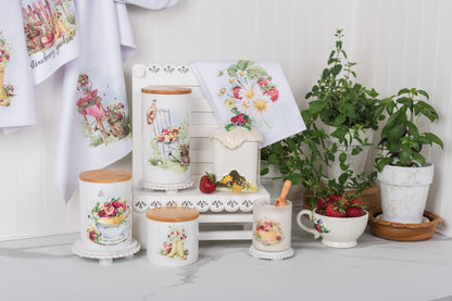 Decorative kitchen items with strawberry designs on a white surface.