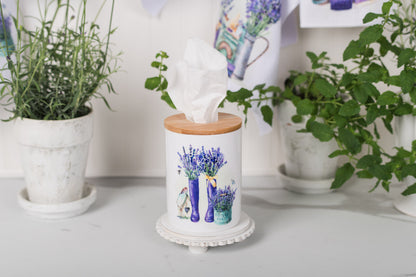 Tissue holder with floral design on a surface with plants around