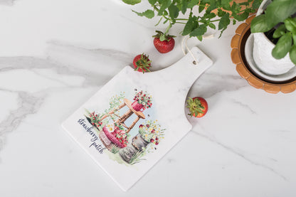 Rectangular ceramic trivet with strawberries and daisies in a cozy kitchen.